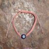 evil eye bracelets in different colours on a brown background